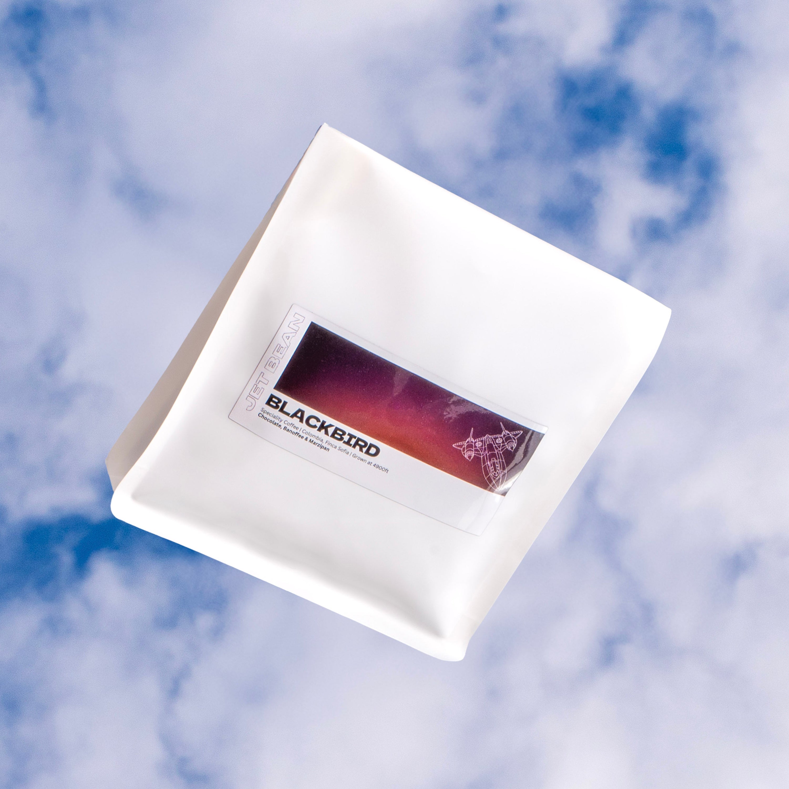 White product packaging with Blackbird branding against a blue sky background