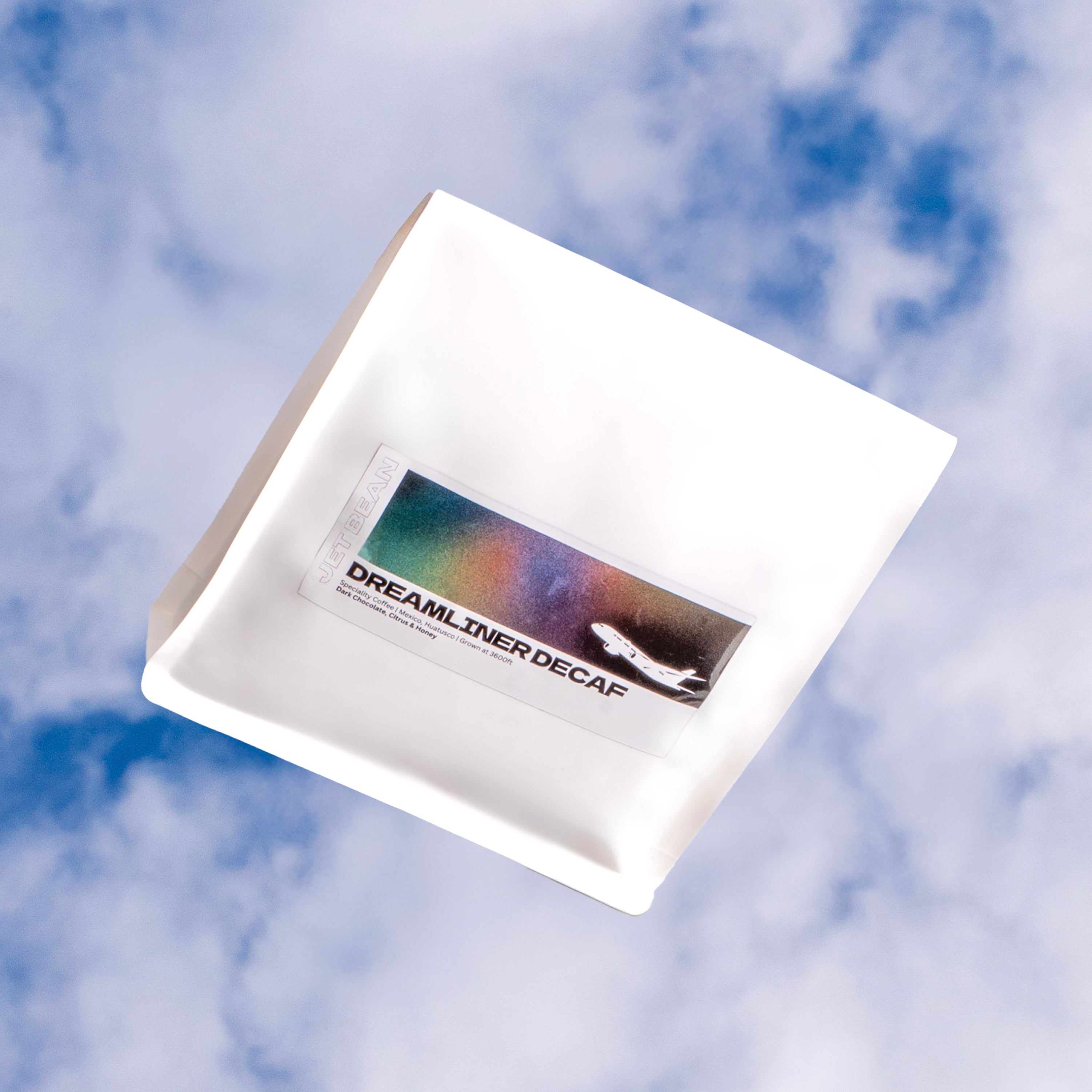 White package with a colorful label on a blue sky background