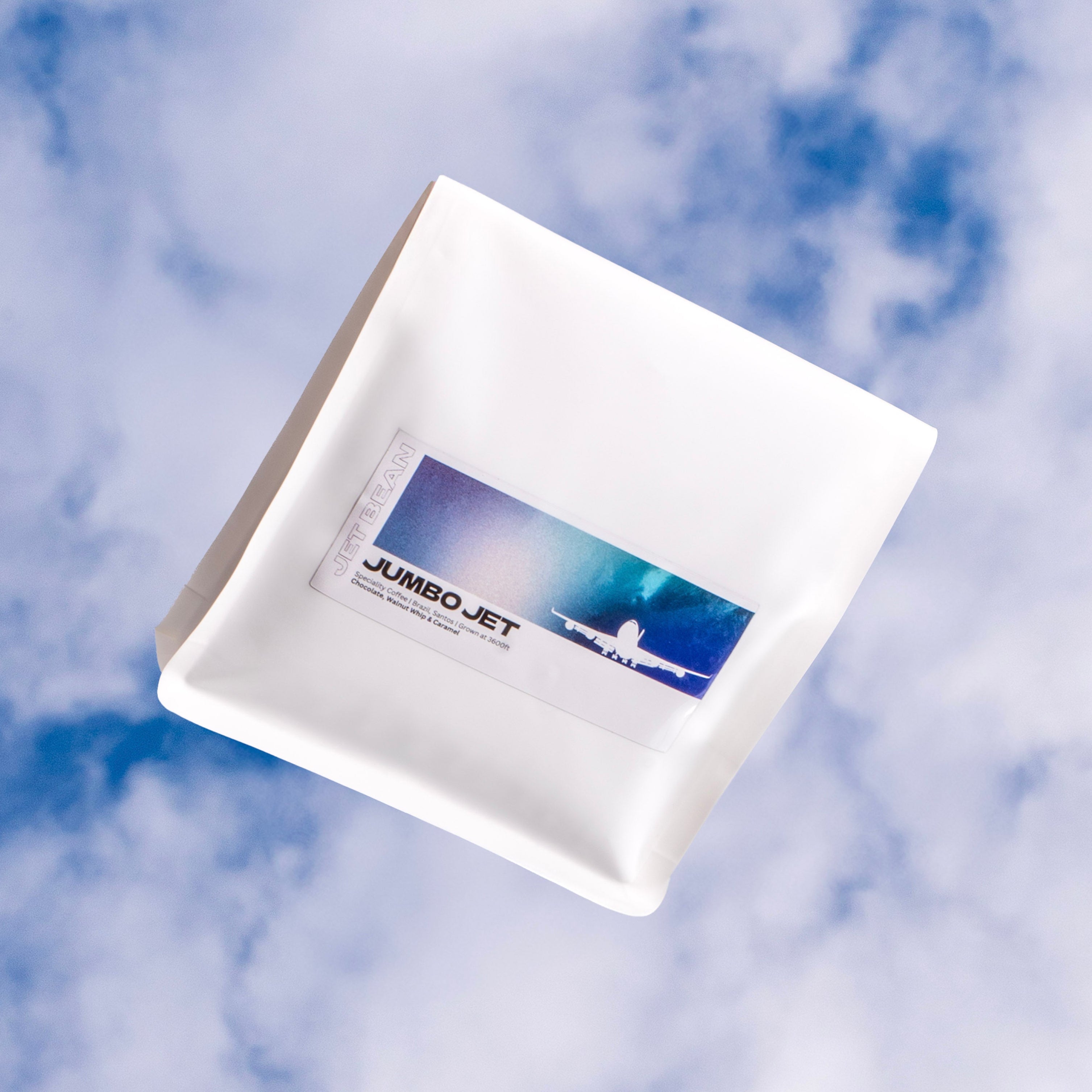 White box with 'JUMBO JET' branding against a cloudy sky background