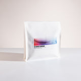 White coffee bag with 'Concorde' branding on a light background