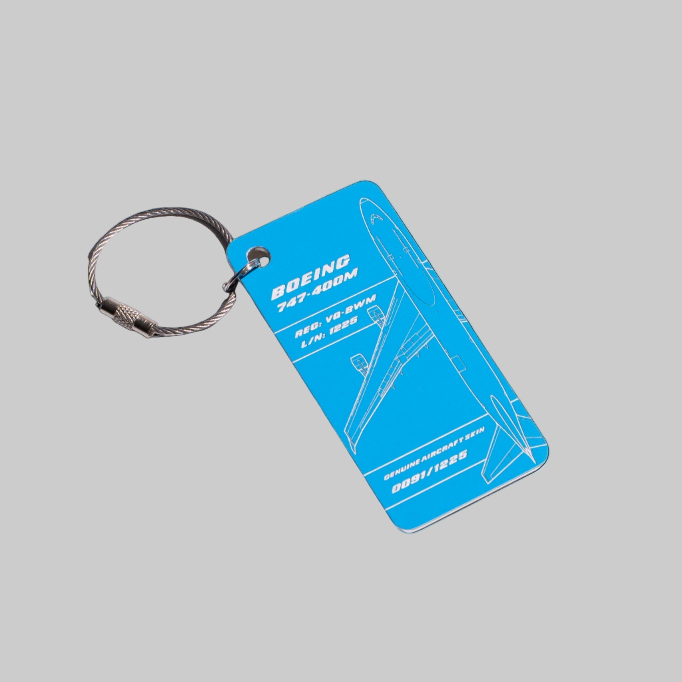 Keychain with blue rectangular tag featuring Boeing 747-800 design on a white background