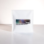 White coffee bag labeled 'Dreamliner Decaf' on a white background