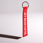 Red keychain with 'Jet Bean Coffee' text on a white background