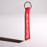 Red keychain with 'Jet Bean Coffee' text on a white background